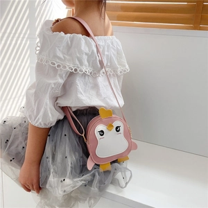 Detailed view of pink penguin crossbody bag with a cute crown on an adjustable strap