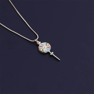Elegant gold lollipop necklace with colorful stones and box chain on dark background