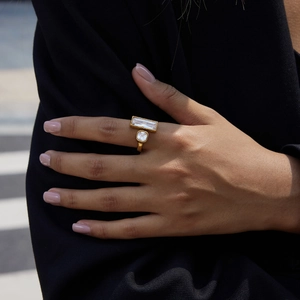 Detail of 18K gold-plated stainless steel open ring with two geometric clear crystals