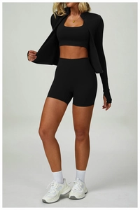 Detailed view of high-waist yoga shorts and matching sports jacket in matte black