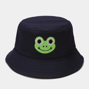 Close-up of navy blue bucket hat featuring a green frog embroidery on cotton fabric