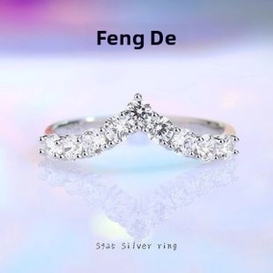Macro view of S925 sterling silver V-shaped crown ring with pavé-set shimmering diamonds