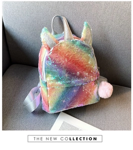 Detail of colorful sequin unicorn backpack with silver horn and plush pink pompom