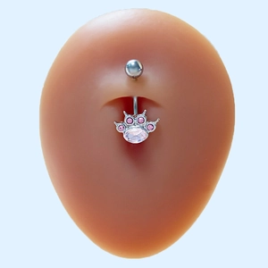 Detailed view of silver cat pendant navel ring with pink gemstone on silicone model