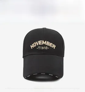 Detailed front view of black cotton baseball cap with gold embroidery and sport logo