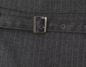 Close-up of metal adjustable buckle and pinstripe fabric texture on grey skirt shorts