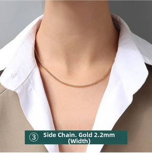 Detail view of a 2.2mm wide gold-plated stainless steel curb chain on a female model