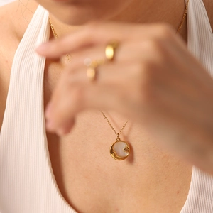 18K gold-plated titanium necklace with celestial white shell pendant on female model