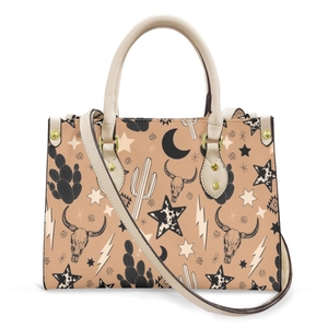 Detail of Western tote bag showing cactus and bull skull prints with white leather handles