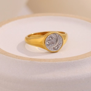 Macro shot of 18K gold moon ring featuring silver center with crystals and ray engravings