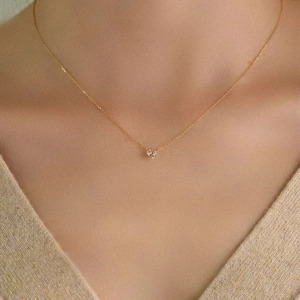 Detailed close-up of a delicate 18K gold plated 925 silver necklace with zircon pendant