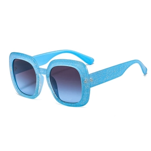 Square oversized blue glitter sunglasses with gradient blue lenses in a 45-degree angle