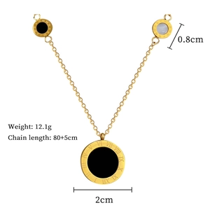 Detail view of gold-plated titanium necklace showing three Roman numeral pendants and dimensions