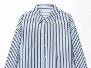 Detail of light blue poplin shirt featuring dark brown vertical stripes and collared neckline