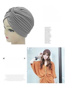 Detail of grey and brown pleated knit turban hats for winter warmth and bohemian style