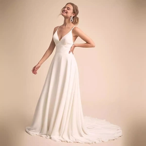 Elegant ivory satin wedding dress with spaghetti straps, deep V-neck and a long train