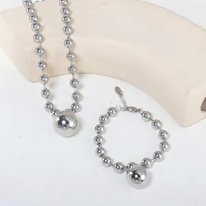 Polished silver stainless steel beaded necklace and bracelet set with hollow ball charm