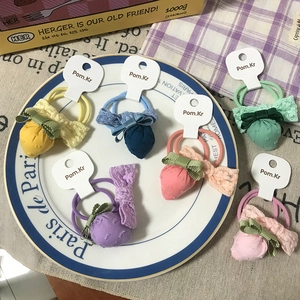 Set of 6 colorful plaid bow strawberry hair ties with lace details on a vintage display