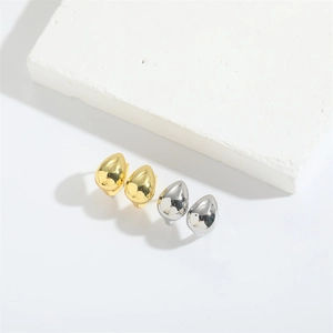 Water droplets stud earrings in gold and silver finish on minimalist white stone background