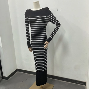 Detail shot of black and white striped knitted maxi dress showing texture and slim fit