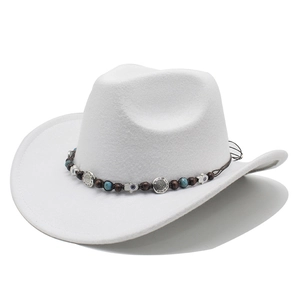 Close-up of white cowboy hat with ethnic braided band and symbolic metal charms