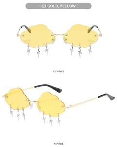 Close-up of yellow cloud-shaped rimless sunglasses with hanging silver lightning charms