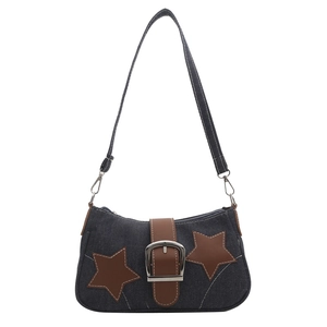 Detail of Y2K denim shoulder bag featuring brown star patches and metal buckle