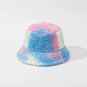 Close-up of fluffy tie-dye faux fur fabric texture on a cozy winter bucket hat