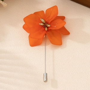 Elegant orange flower brooch with translucent resin petals and long silver metal pin