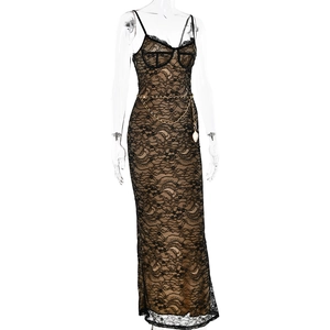 Detailed view of black lace maxi dress featuring nude lining and gold chain belt accessory