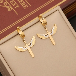 Golden winged cross earrings with rhinestones displayed in a beige jewelry gift box