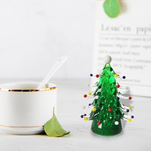 Detailed view of a green glass Christmas tree figurine with colorful bead ornaments
