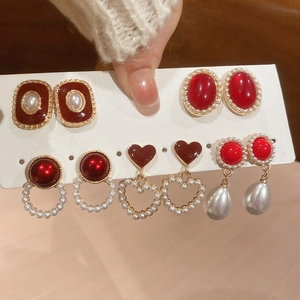 Detailed set of vintage earrings with red resin charms and imitation pearls in gold plating