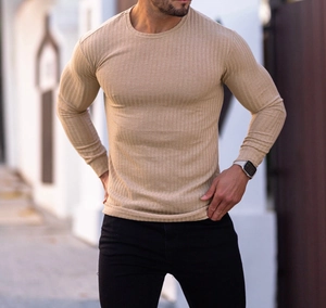 Detail of men's slim fit long sleeve shirt showing khaki ribbed fabric texture and crew neck