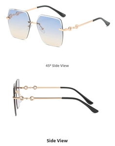 Detail view of rimless square sunglasses with blue-orange gradient lenses and gold temples