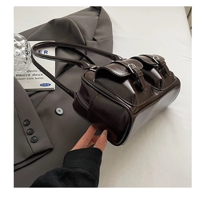Detail of dark brown vintage shoulder bag with glossy leather and dual front pockets