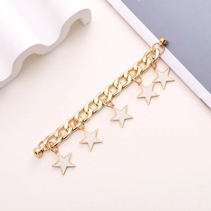 Detail of gold Cuban chain with white enamel star charms and secure magnetic clasps