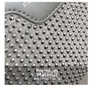 Macro shot of silver rhinestone saddle bag featuring detailed metallic stud embellishments