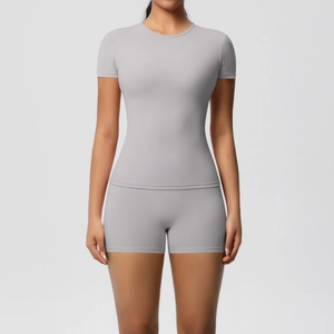 Front view of light grey seamless athletic set with slim-fit short sleeve tee and biker shorts