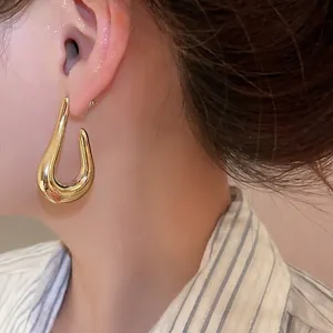Polished gold teardrop hoop earrings for women with minimalist curved metal design