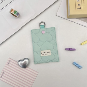Detail of mint green quilted heart pattern card holder with silver D-ring and button
