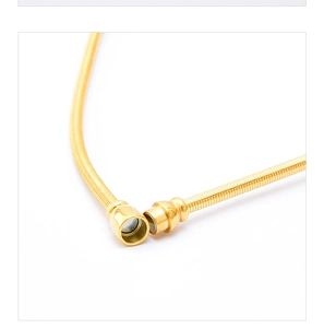Detailed close-up of a magnetic clasp on a polished gold snake chain necklace