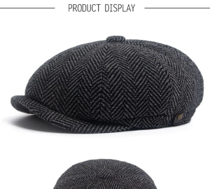 Detail of dark grey herringbone newsboy cap with metal emblem and classic wool texture