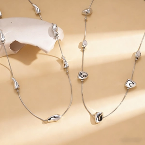 Minimalist irregular geometric silver bead necklace with liquid metal style pendants