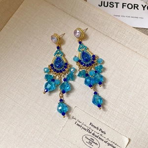 Detailansicht von Vintage Goldohrringen mit blauen Kristallfransen und Edelsteinen