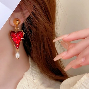 Retro red heart stud earrings with gold beads and pearl drop on model view