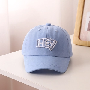 Detail of light blue kids baseball cap featuring HEY letter embroidery and cotton texture