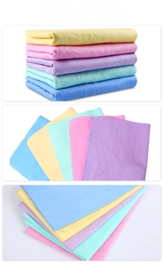 Close-up of multi-color thick absorbent pet towels in yellow, pink, purple, and mint green