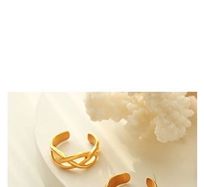 Detail of a 18K gold plated twisted rope ring showing the intricate braided texture