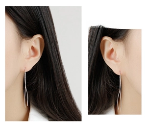 Detailed view of S925 sterling silver long wave threader earrings on a model